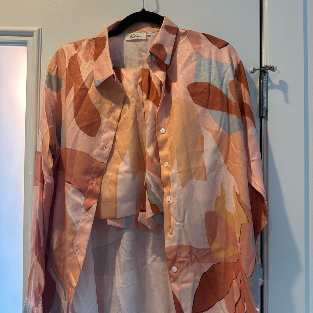 Never been worn. Complete set with shorts and top included. Both size medium